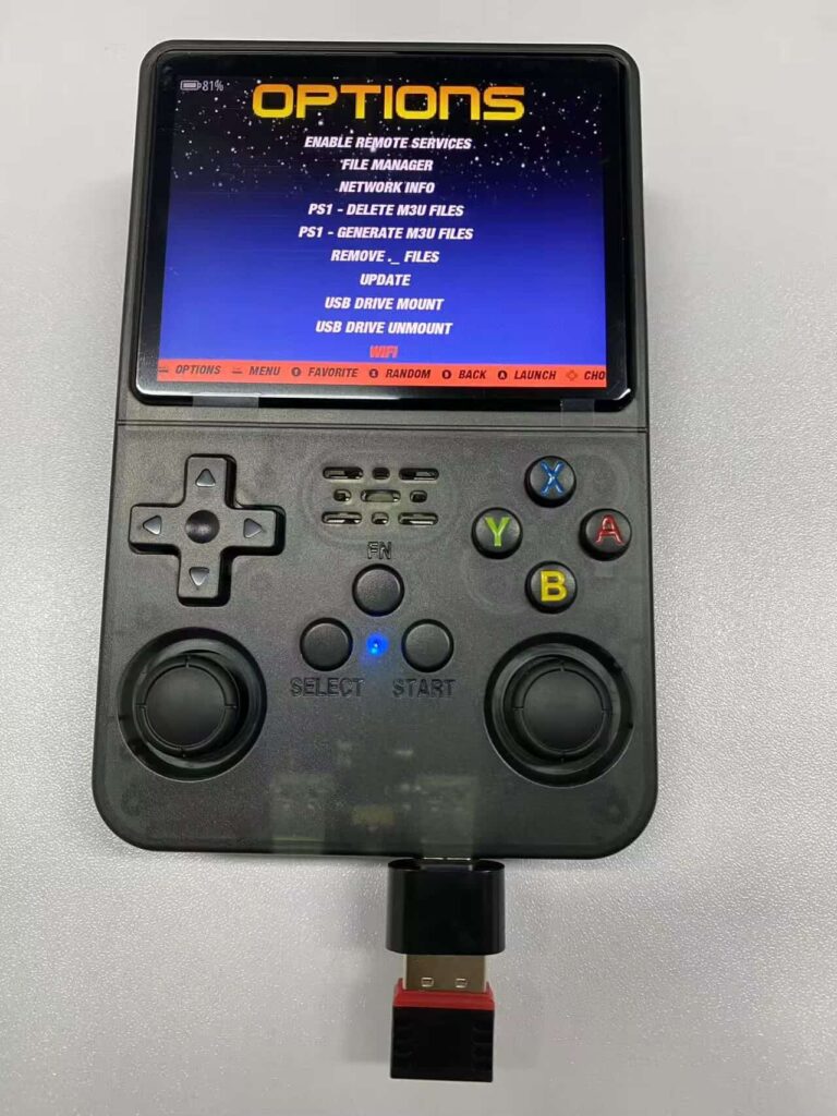 Close-up of the USB-C OTG port on the bottom of an R36S with a WiFi adapter plugged in